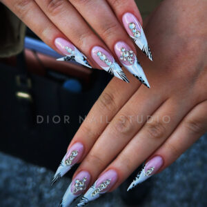Dolgi stiletto nohti z roza bazo, belimi konicami, črnimi zebrastimi linijami in kristali – Dior Nail Studio, Ljubljana